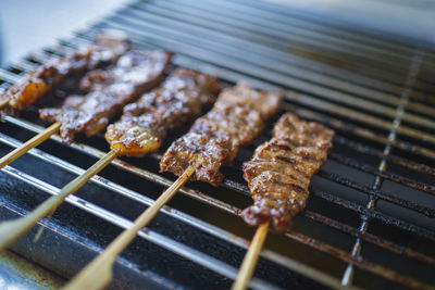 Close-up of meat on barbecue grill