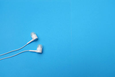 Close-up of electric lamp against blue background