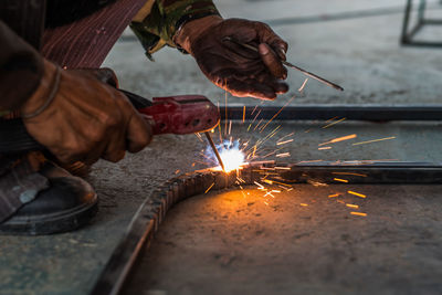 Low angle view of welder welding in workshop