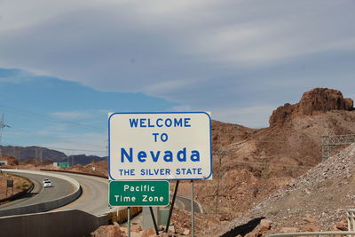 Road sign against sky