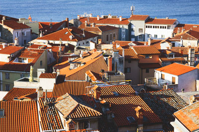 Red roofs of old town piran with main church against the sunrise sky, adriatic sea. slovenia