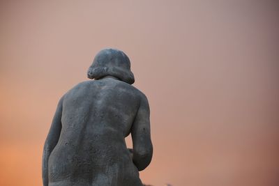 Low angle view of statue against clear sky during sunset