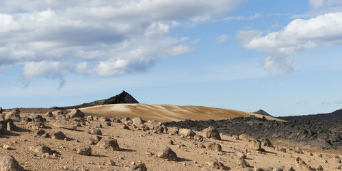 View of desert against cloudy sky