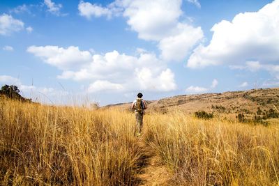 Man standing on field against sky