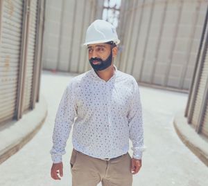 Portrait of young man standing in city