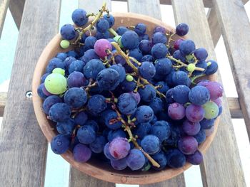 High angle view of grapes in container on table