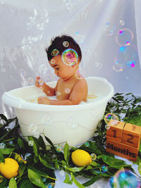 High angle view of toys in bathtub and baby