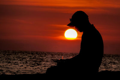 Silhouette woman on beach during sunset