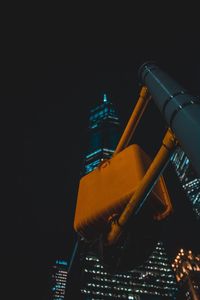 Close-up of illuminated building against sky at night