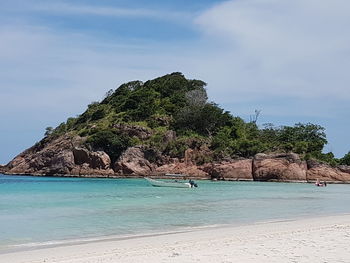 View of calm beach against blue sky