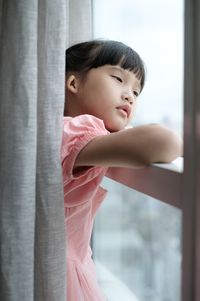 Side view of cute baby girl at home