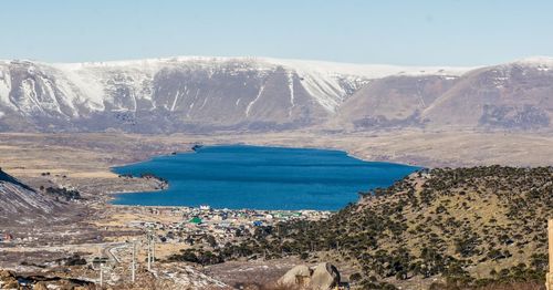 Scenic view of lake and mountains against sky