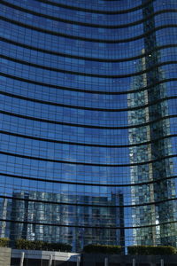 Low angle view of skyscrapers against blue sky