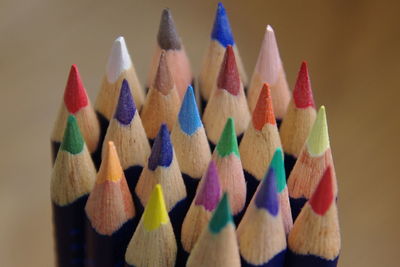 Close-up of multi colored pencils against colored background