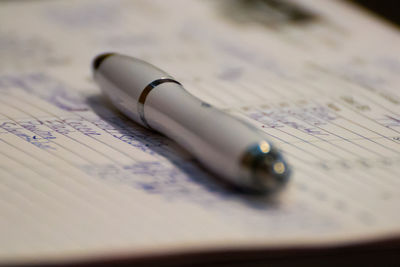 Close-up of pen on book