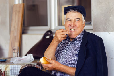 Portrait of smiling man holding ice cream