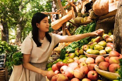 Young woman picking apples