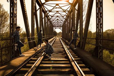 Railroad tracks amidst bridge against sky