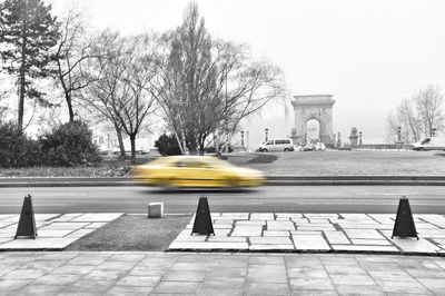 Yellow umbrella on road in city