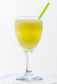 Close-up of beer glass on white background