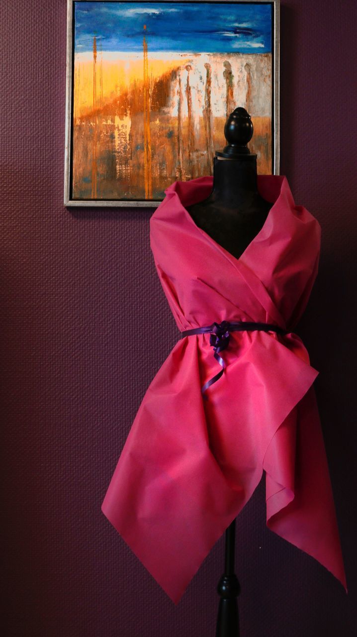 CLOSE-UP OF PINK GLASS HANGING AGAINST WINDOW