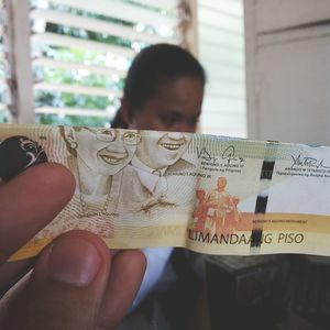 Close-up of man holding paper