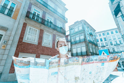 Woman reading map in city