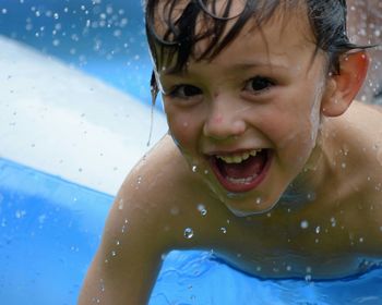 Portrait of young boy in water