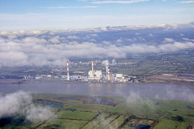 View of factory against cloudy sky