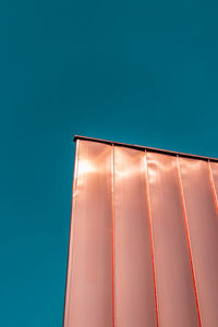 Copper sheet panels against a turquoise sky