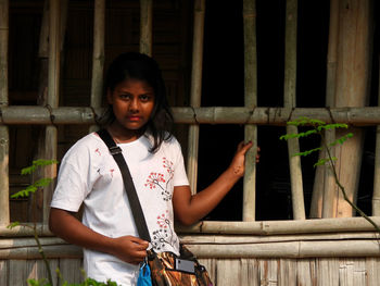 Portrait of a bengali girl standing against window 