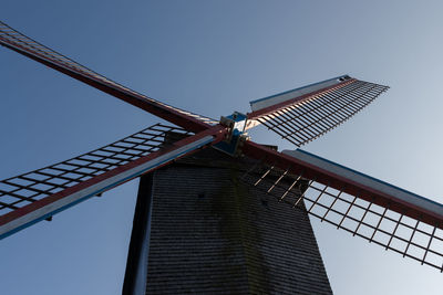 Low angle view of traditional windmill against clear sky