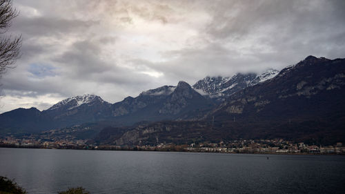 Scenic view of lake by mountains against sky