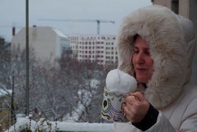 Young man drinking coffee in winter