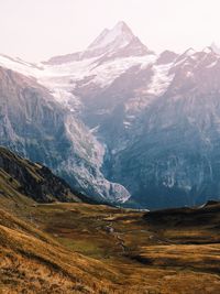 Scenic view of mountains against cloudy sky