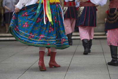 Low section of women walking on tiled floor