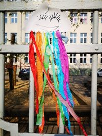 Close-up of multi colored flags hanging on building