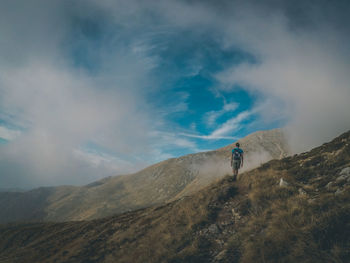 Man on mountain against sky