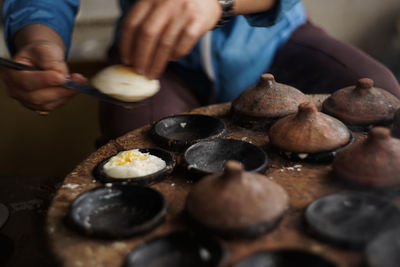 Midsection of man preparing food
