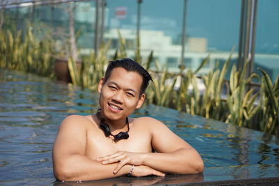 Portrait of shirtless man in swimming pool