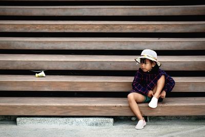 Full length of boy sitting on steps