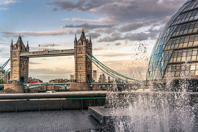 View of bridge over river against cloudy sky