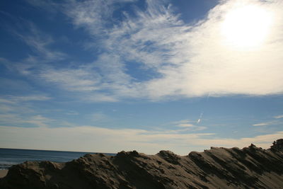 Scenic view of sea and mountains against sky