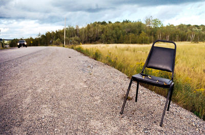 Empty road against cloudy sky