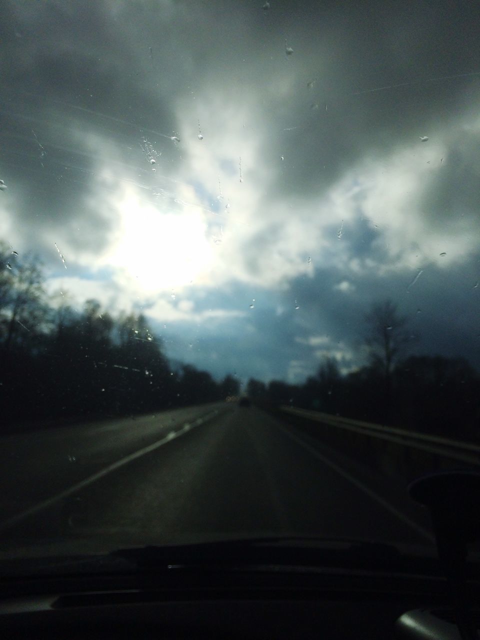 transportation, road, windshield, vehicle interior, the way forward, sky, transparent, car, glass - material, mode of transport, land vehicle, car interior, road marking, diminishing perspective, cloud - sky, car point of view, country road, tree, vanishing point, travel