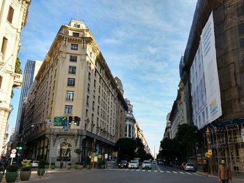 Street amidst buildings in city against sky