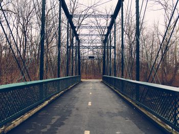 Empty road amidst trees in forest