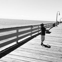 Woman standing on pier