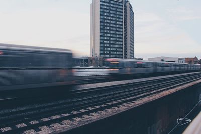 Blurred motion of train against sky in city