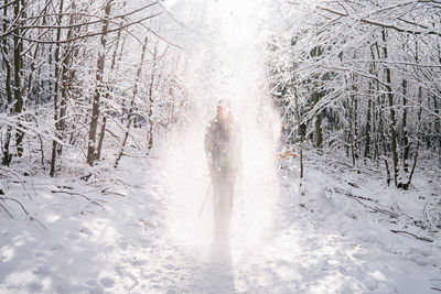 Full length of woman standing on snow covered land